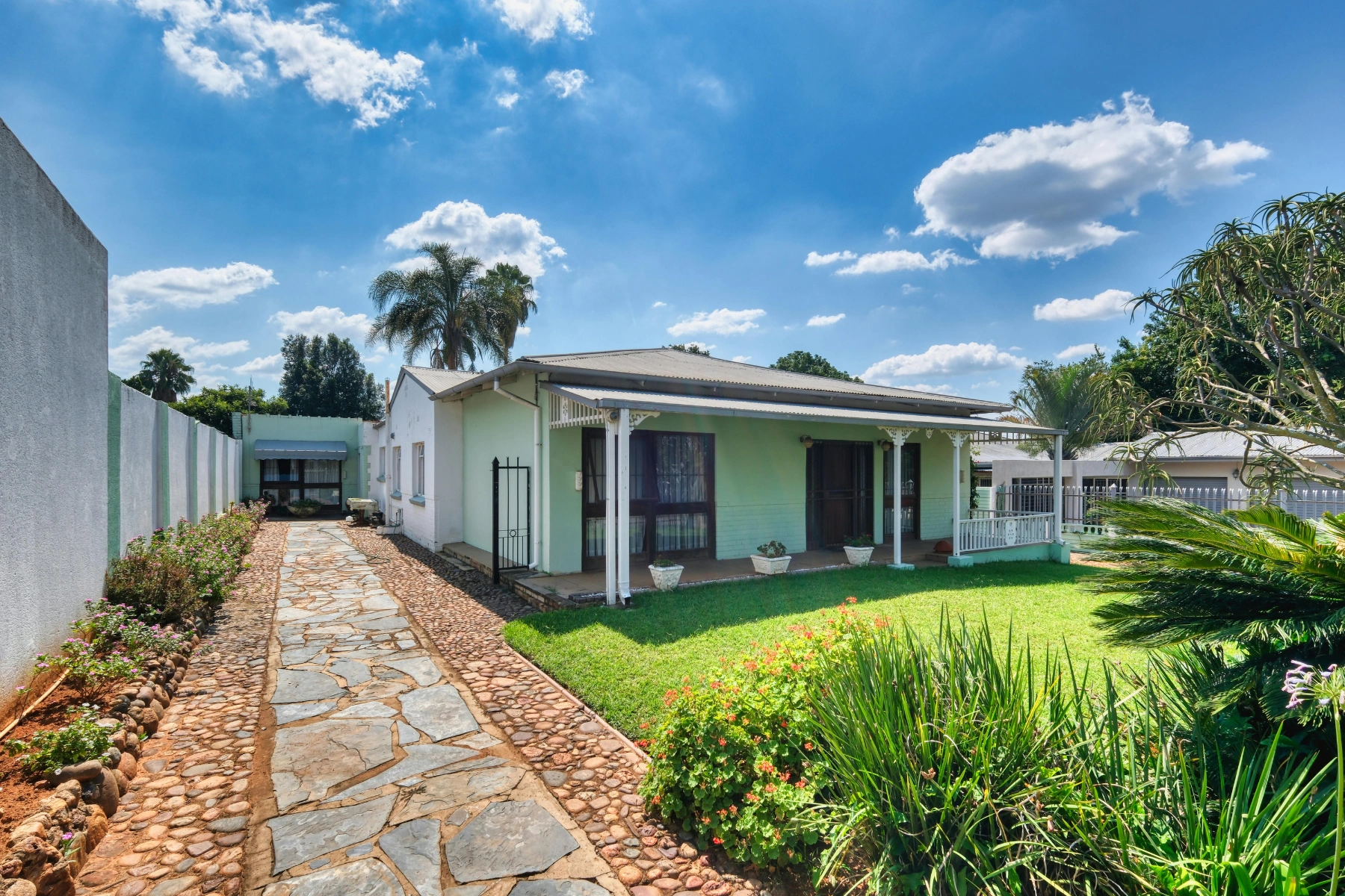 Worker Installing Solar Panels on Residential Roof